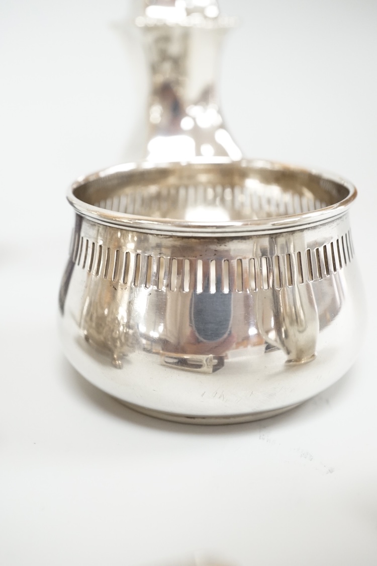 Four assorted silver condiments including a Victorian bun salt and a late Victorian pepper mill, together with a small silver bowl, a silver matchbox sleeve and a small silver two handled cup.